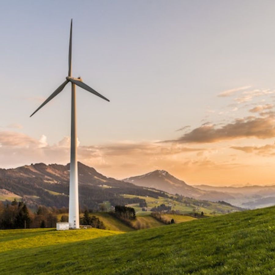 a wind turbine with a mountain in the background