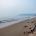 “Hazy Sauble Beach shoreline with muted colors and reduced visibility over the water from wildfire smoke.”