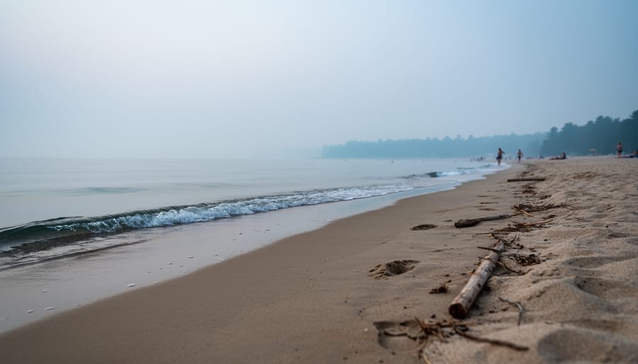 “Hazy Sauble Beach shoreline with muted colors and reduced visibility over the water from wildfire smoke.”