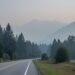 View across the Fraser Valley near Chilliwack showing wildfire smoke haze that softens distant hills and reduces visibility at dusk.