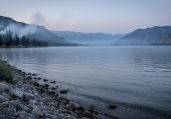 Hazy mountain and lake valley scene in Osoyoos suggesting lingering air pollution and wind-driven dispersion.