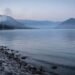 Hazy mountain and lake valley scene in Osoyoos suggesting lingering air pollution and wind-driven dispersion.